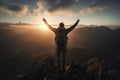 Man with backpack standing with arms raised on mountain peak at sunset Royalty Free Stock Photo