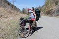 Man with a backpack standing at bicycle and drinking water Royalty Free Stock Photo