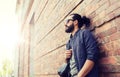 Man with backpack standing at city street wall Royalty Free Stock Photo