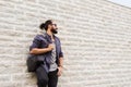 Man with backpack standing at city street wall Royalty Free Stock Photo