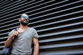 Man with backpack standing at city street wall Royalty Free Stock Photo