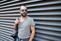 Man with backpack standing at city street wall Royalty Free Stock Photo