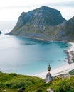 A man with a backpack stands on top of a mountain Royalty Free Stock Photo