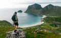 A man with a backpack stands on top of a mountain Royalty Free Stock Photo