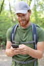 man with backpack using smart phone on beautiful nature Royalty Free Stock Photo