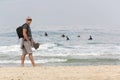 A man with a backpack is walking along the sea