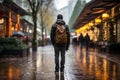 a man with a backpack walks along an evening road in the rain generative ai Royalty Free Stock Photo