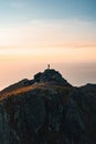 Man backpacker standing on mountain summit alone active travel in Norway hiking outdoor healthy lifestyle Royalty Free Stock Photo