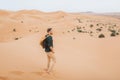 Man backpacker travel in Morocco, Sahara desert. Freedom and lifestyle concept. Royalty Free Stock Photo