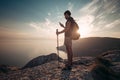 Man backpacker using smartphone relaxing on mountain Royalty Free Stock Photo