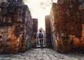 Man backpacker walking inside in Prasat Muang Sing are Ancient ruins of Khmer temple