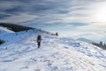 Man is backpacking in winter mountains