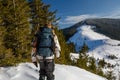 Man is backpacking in winter mountains