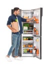 Man with bag of groceries near refrigerator on white background Royalty Free Stock Photo