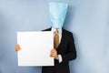 Man with bag over head holding blank sign