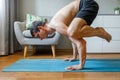 Man in bakasana pose doing vinyasa yoga flow Royalty Free Stock Photo