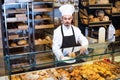 Man baker showing warm tasty croissant Royalty Free Stock Photo