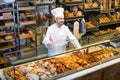 Man baker showing warm tasty croissant Royalty Free Stock Photo