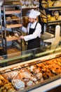 Man baker showing warm tasty croissant Royalty Free Stock Photo