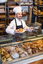 Man baker showing warm tasty croissant Royalty Free Stock Photo