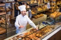 Man baker showing warm tasty croissant Royalty Free Stock Photo