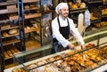 Man baker showing warm tasty croissant Royalty Free Stock Photo