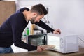 Man Baking Pizza In Microwave Oven Royalty Free Stock Photo