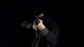 A man in a balaclava mask stands with an AK-47 assault rifle. The bandit stands with a gun on his shoulder, and then Royalty Free Stock Photo