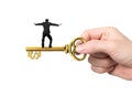 Man balance on treasure key in dollar sign shape