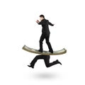 Man balancing on running money with legs Royalty Free Stock Photo