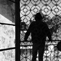 Man on balcony of abandoned house