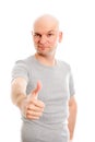 Man with bald head and thumb up is looking friendly in to the ca Royalty Free Stock Photo
