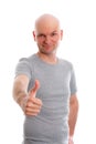 Man with bald head and thumb up is looking friendly in to the ca Royalty Free Stock Photo