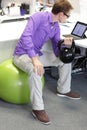 Man on ball working out with kettlebell during offce work Royalty Free Stock Photo