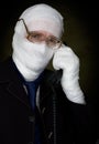 Man in bandage calling on phone Royalty Free Stock Photo