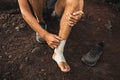 Man bandaging injured ankle. First aid for leg Royalty Free Stock Photo