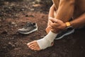 Man bandaging injured ankle. First aid for leg Royalty Free Stock Photo