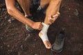 Man bandaging injured ankle. First aid for leg Royalty Free Stock Photo