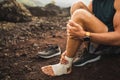 Man bandaging injured ankle. First aid for leg Royalty Free Stock Photo