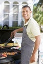 Man Barbequing In A Garden Royalty Free Stock Photo