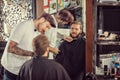 Man barber with scissors cut the beard Royalty Free Stock Photo