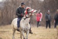 Man is bareback riding an adorned horse before an Epiphany celebration horse race