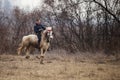 Man is bareback riding an adorned horse before an Epiphany celebration horse race