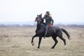 Man is bareback riding an adorned horse before an Epiphany celebration horse race