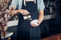 Man barista pour milk into hot coffee cup at counter bar in front of machine in cafe restaurant,Food business owner concept Royalty Free Stock Photo