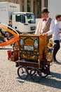 Man with barrel organ in city on sunny day Royalty Free Stock Photo