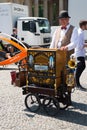 Man with barrel organ in city on sunny day Royalty Free Stock Photo