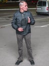 A man with a baseball cap in his hands at night on the street Royalty Free Stock Photo