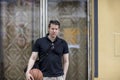 Man With a Basketball Near a House Window Royalty Free Stock Photo