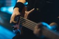 Man bass guitarist playing electrical guitar on concert stage Royalty Free Stock Photo